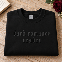 Load image into Gallery viewer, Black Dark Romance Reader crewneck with black gothic embroidery, styled with a burgundy rose and book.